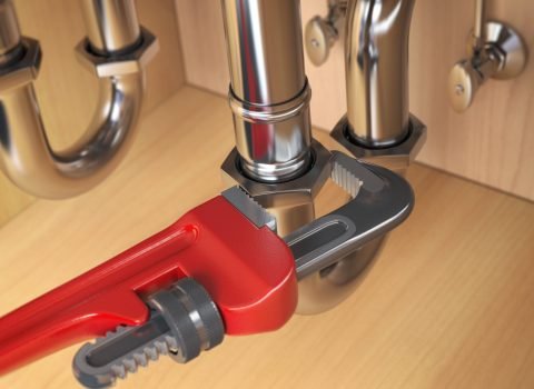 Pllumber using an ajustable wrench to repair a water pipe under the sink. 3d illustration